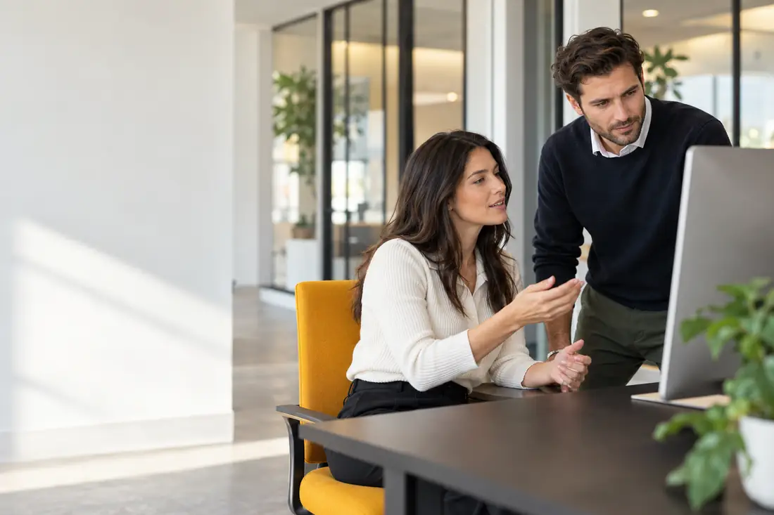 Two colleagues reviewing a customer follow-up on screen